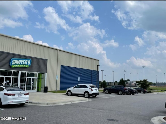view of building exterior with uncovered parking