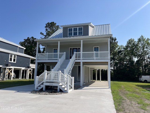 3216 Whichards Beach Rd, Chocowinity, NC 27817 - coastal inspired home with a carport, concrete driveway, covered porch, stairway, and metal roof