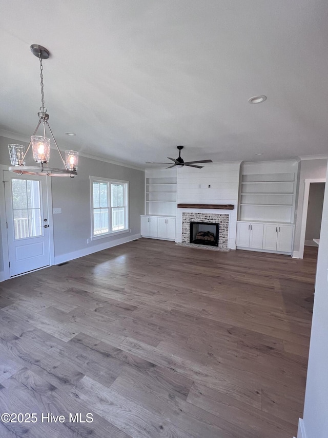 3216 Whichards Beach Rd, Chocowinity, NC 27817 - unfurnished living room featuring crown molding, ceiling fan, baseboards, a tile fireplace, and a chandelier