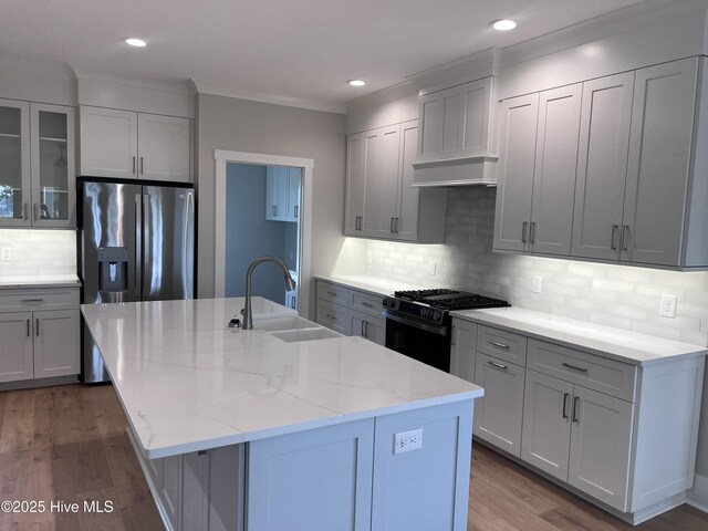 3216 Whichards Beach Rd, Chocowinity, NC 27817 - kitchen featuring a sink, gas stove, decorative backsplash, wood finished floors, and light stone counters