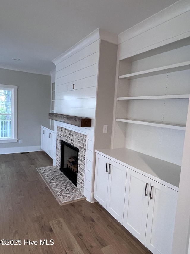 3216 Whichards Beach Rd, Chocowinity, NC 27817 - unfurnished living room featuring dark wood-type flooring, a fireplace, built in shelves, and baseboards