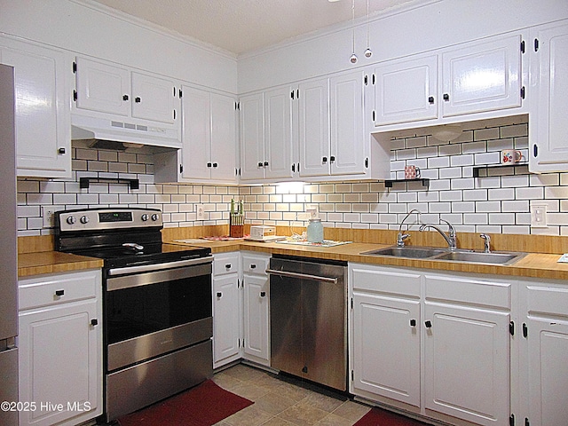 kitchen featuring ornamental molding, white cabinetry, under cabinet range hood, appliances with stainless steel finishes, and a sink
