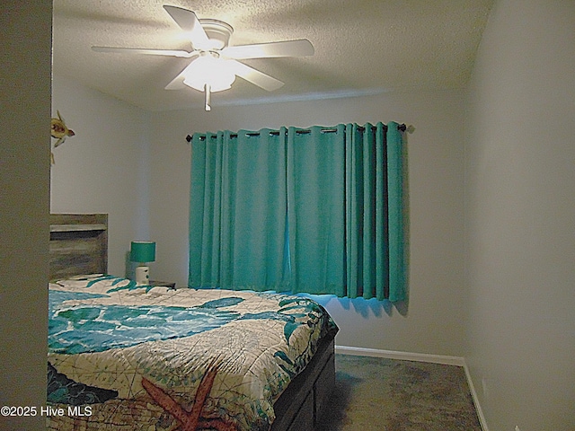bedroom featuring baseboards, ceiling fan, and a textured ceiling