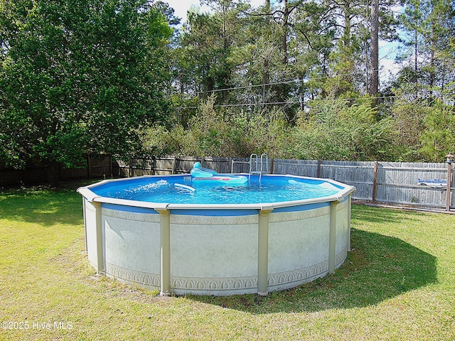 view of pool with a yard, a fenced backyard, and a fenced in pool