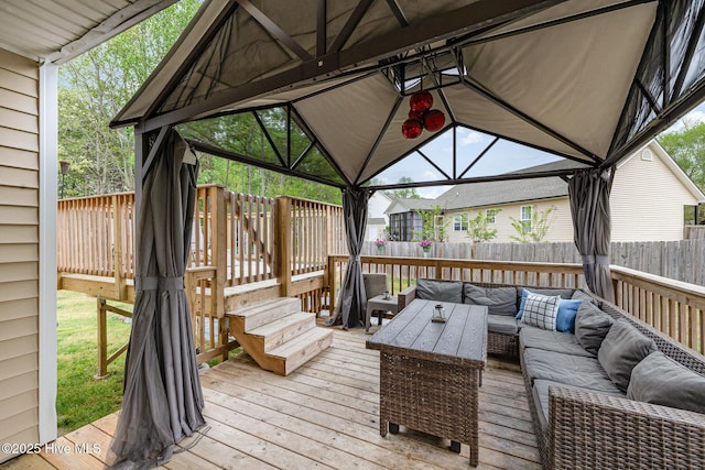 deck featuring an outdoor living space, a gazebo, and fence