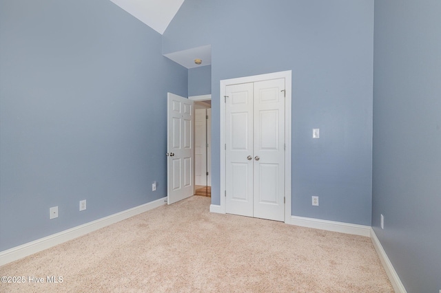 unfurnished bedroom with a closet, baseboards, and carpet