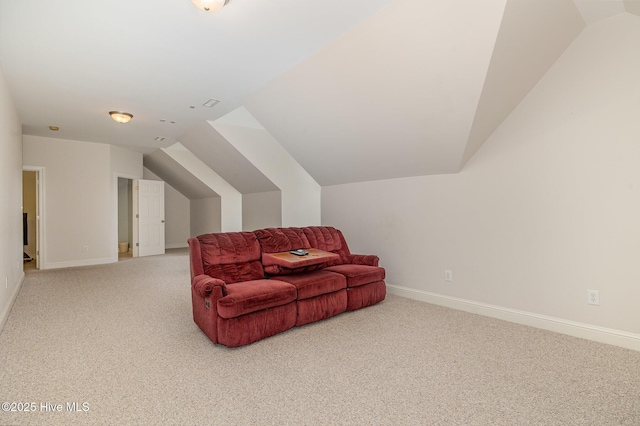 living area with baseboards, vaulted ceiling, and light carpet