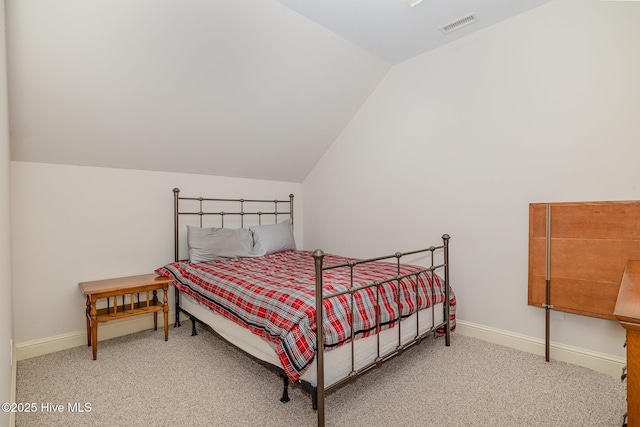 carpeted bedroom with visible vents, baseboards, and vaulted ceiling