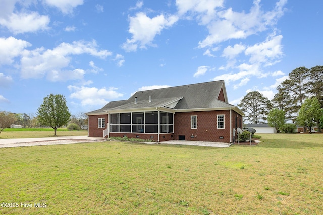 back of house with a sunroom, crawl space, a lawn, brick siding, and a shingled roof