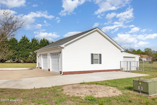 detached garage featuring fence
