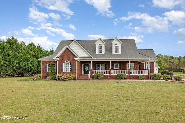 cape cod-style house with brick siding, a front yard, and a porch