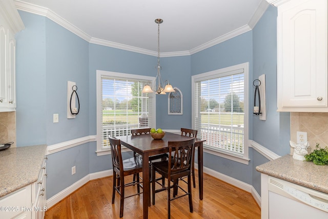 dining space featuring plenty of natural light, light wood-style floors, baseboards, and an inviting chandelier