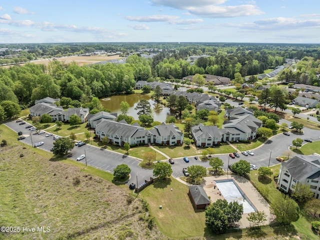 birds eye view of property with a water view and a residential view