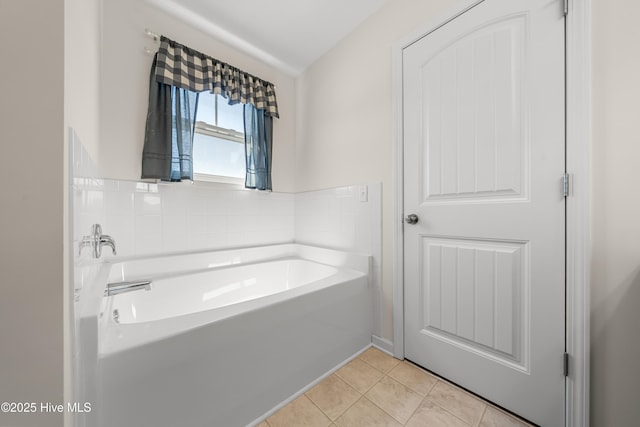 full bathroom featuring tile patterned flooring and a bath