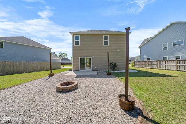 back of property featuring an outdoor fire pit, fence, a patio, and a lawn