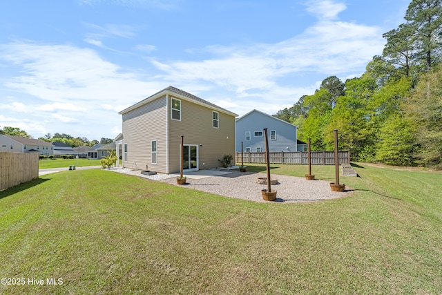 rear view of property with a patio area, fence, and a yard