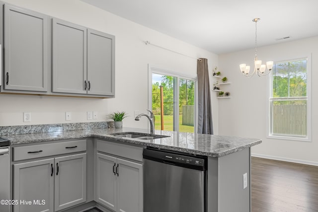 kitchen featuring gray cabinetry, a peninsula, dishwasher, and a sink