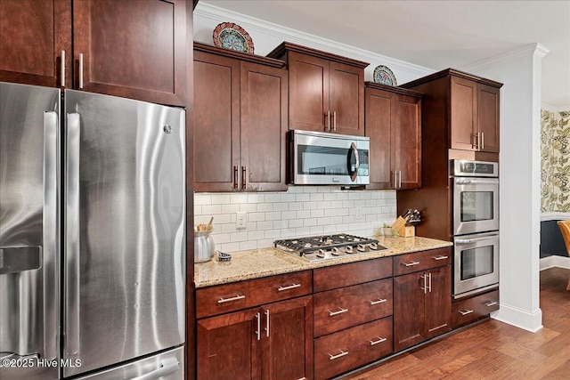 104 Old Club House Ln, Southern Pines, NC 28387 - kitchen with dark wood-style flooring, light stone countertops, stainless steel appliances, baseboards, and ornamental molding