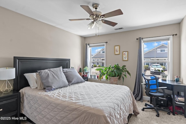 bedroom featuring a ceiling fan, baseboards, visible vents, and carpet floors