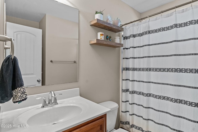 bathroom featuring vanity, toilet, and a shower with shower curtain