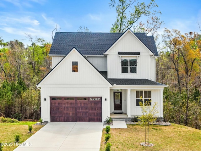 modern farmhouse with a garage, a porch, roof with shingles, a front yard, and concrete driveway