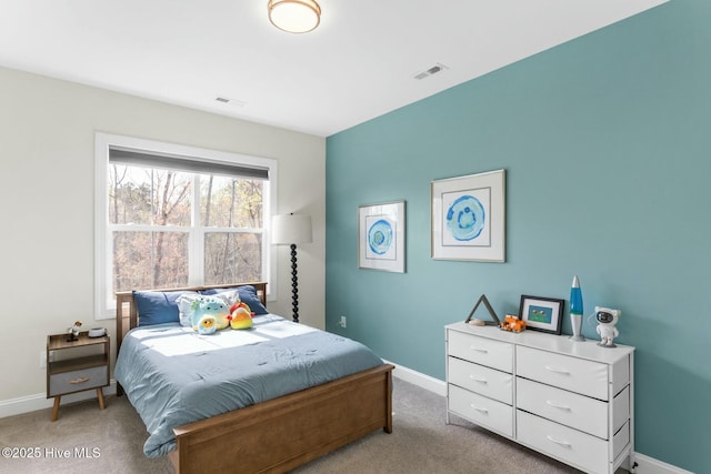 carpeted bedroom with baseboards and visible vents