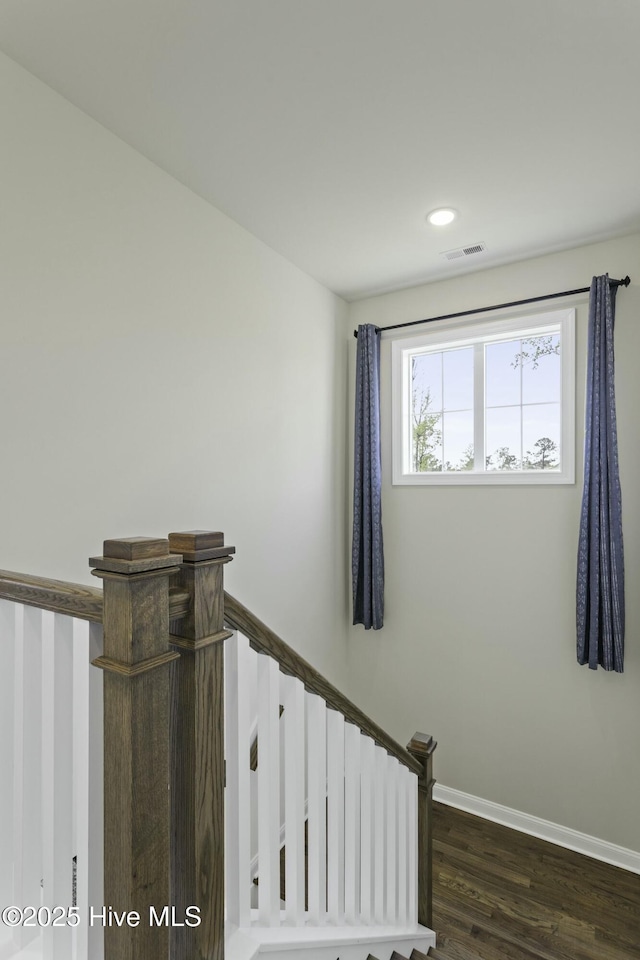 stairs with recessed lighting, visible vents, baseboards, and wood finished floors