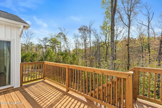 wooden deck with a wooded view