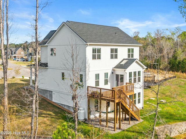 back of property with stairway, a wooden deck, and a shingled roof