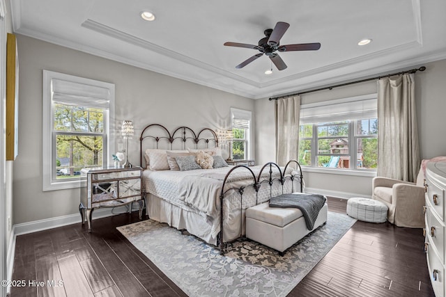 bedroom with ornamental molding, recessed lighting, a raised ceiling, baseboards, and dark wood-style floors