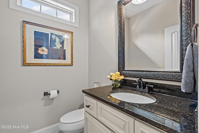 bathroom with toilet and vanity