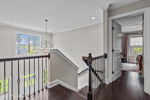 stairway featuring baseboards, recessed lighting, hardwood / wood-style floors, and a chandelier
