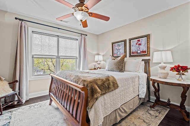 bedroom with ceiling fan, baseboards, visible vents, and wood finished floors