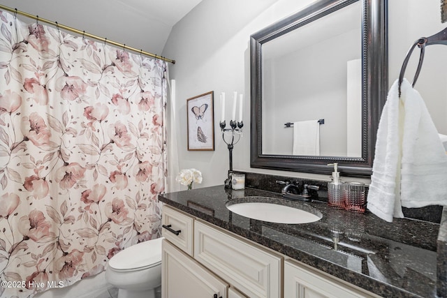 bathroom with toilet, a shower with shower curtain, and vanity