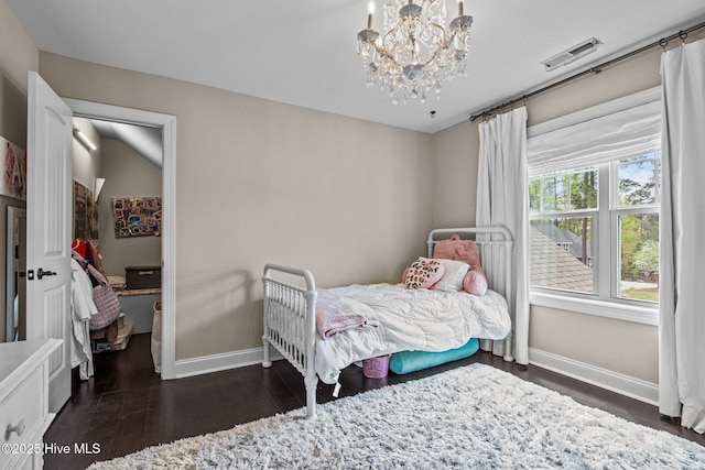 bedroom with a chandelier, baseboards, dark wood finished floors, and visible vents