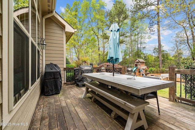 deck with outdoor dining area and area for grilling