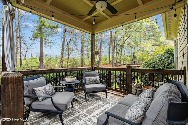 wooden deck with ceiling fan and an outdoor hangout area