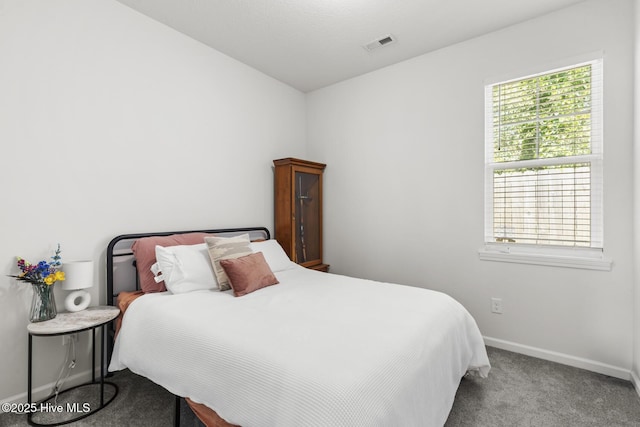 carpeted bedroom featuring visible vents and baseboards