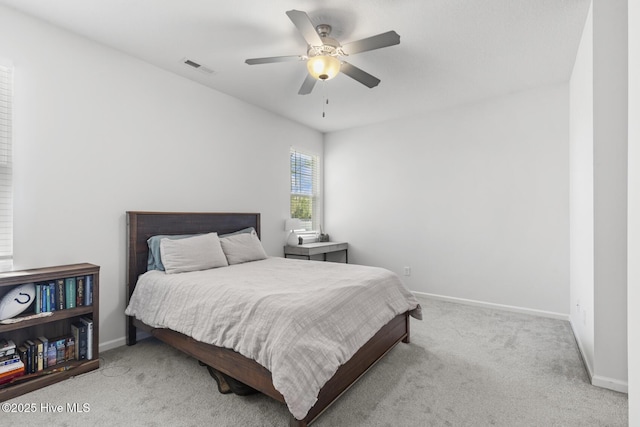 bedroom with visible vents, baseboards, a ceiling fan, and carpet