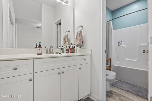 full bathroom with toilet, shower / tub combo with curtain, vanity, and wood finished floors