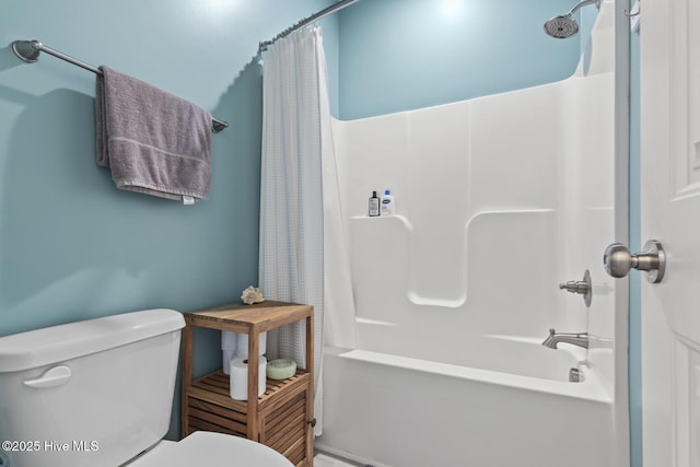 bathroom with shower / bath combo with shower curtain and toilet