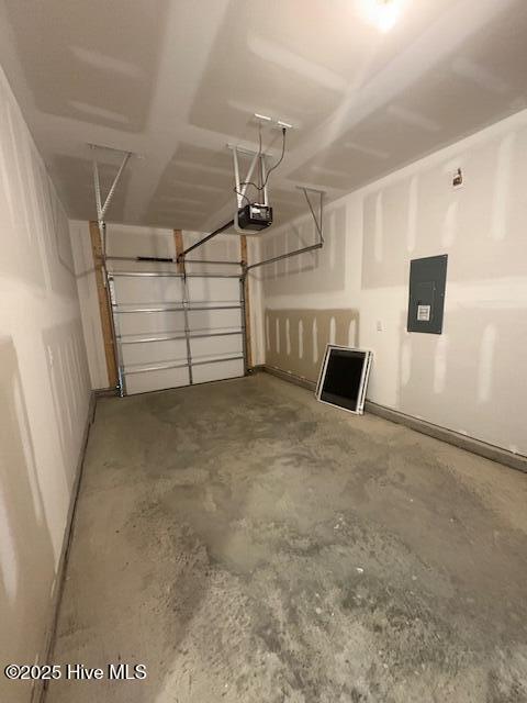 garage with a garage door opener and electric panel