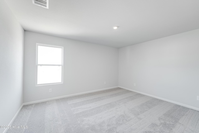 carpeted empty room with baseboards and visible vents