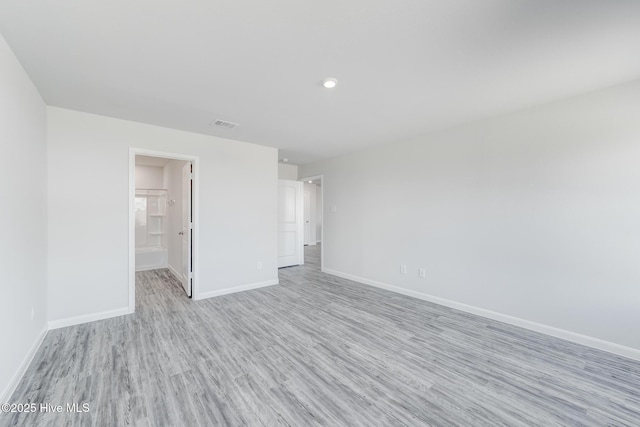unfurnished bedroom with recessed lighting, light wood finished floors, visible vents, and baseboards