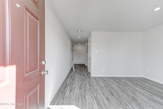 spare room with visible vents, baseboards, recessed lighting, and wood finished floors