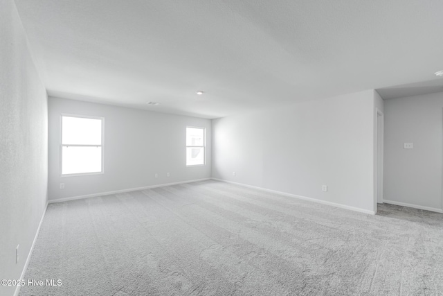 unfurnished room featuring carpet flooring and baseboards