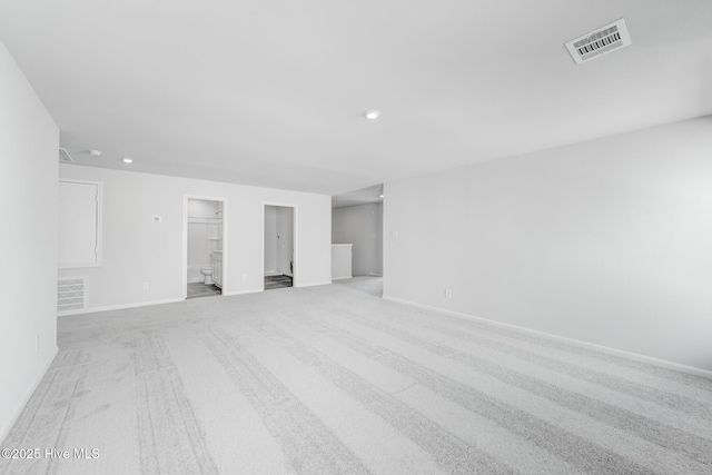 empty room with light colored carpet, baseboards, visible vents, and recessed lighting
