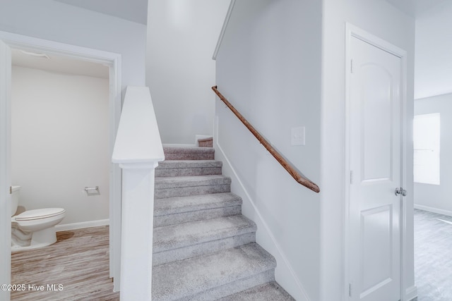 stairs featuring baseboards and wood finished floors