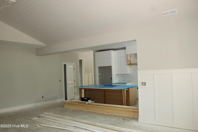 3359 Portside Dr SW, Supply, NC 28462 - kitchen with white cabinets, a decorative wall, a wainscoted wall, and a center island