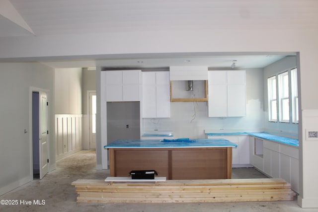 3359 Portside Dr SW, Supply, NC 28462 - kitchen with a kitchen island, white cabinetry, concrete floors, and modern cabinets